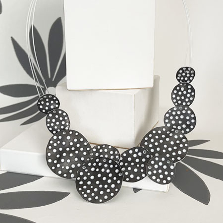 Bib necklace in grey